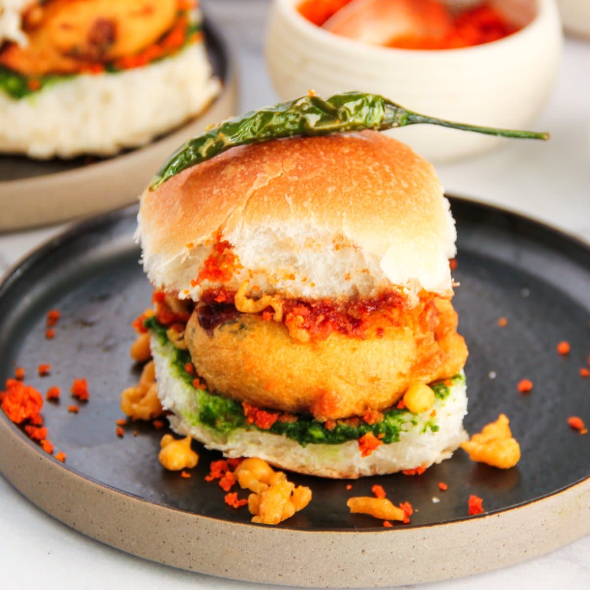 vada pav topped with fried mirchi 