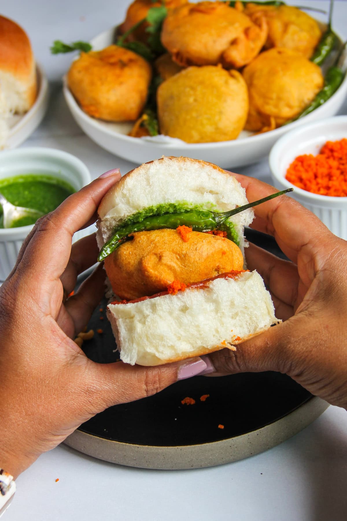 closeup photo of vada pav in hands 