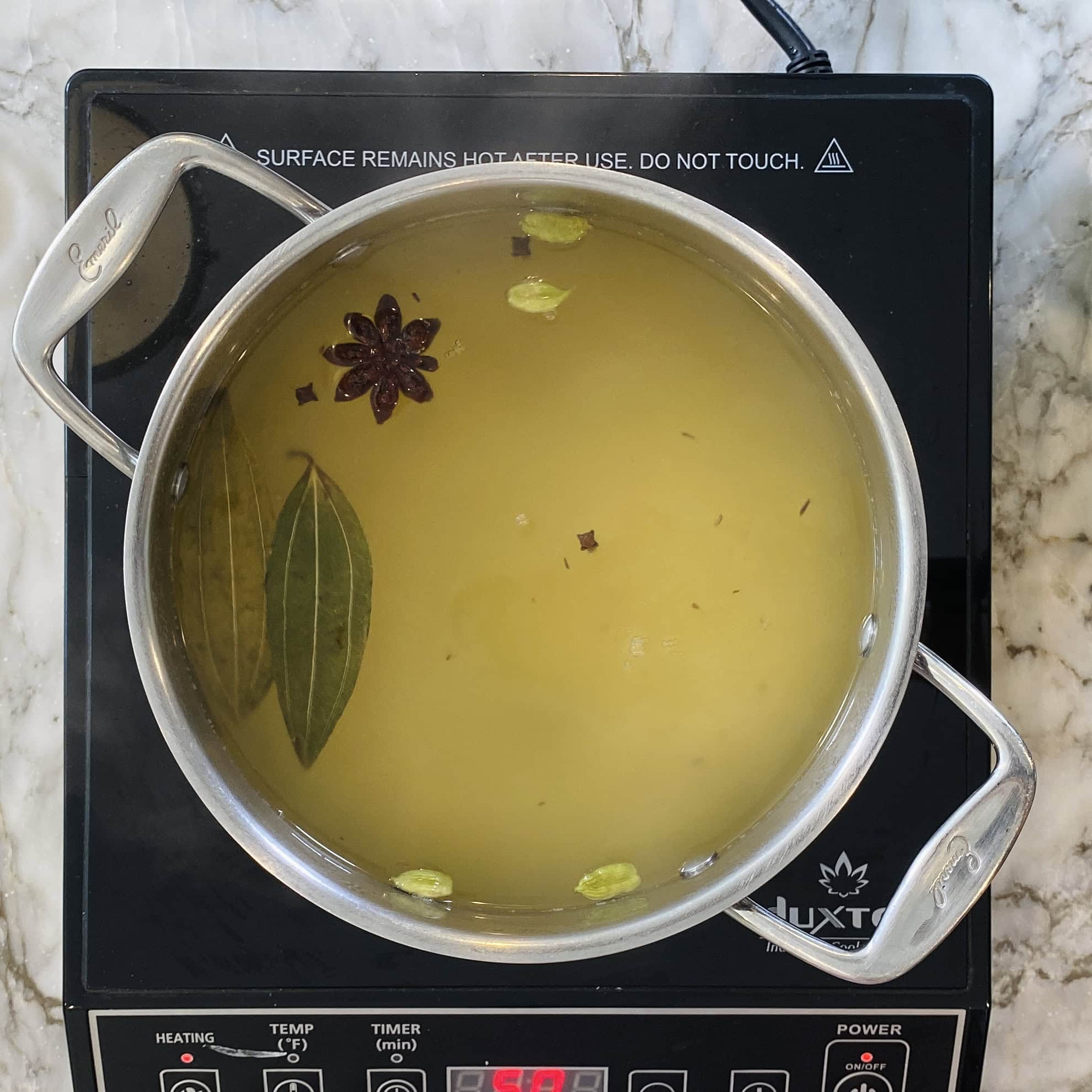 pot with water and whole spices 