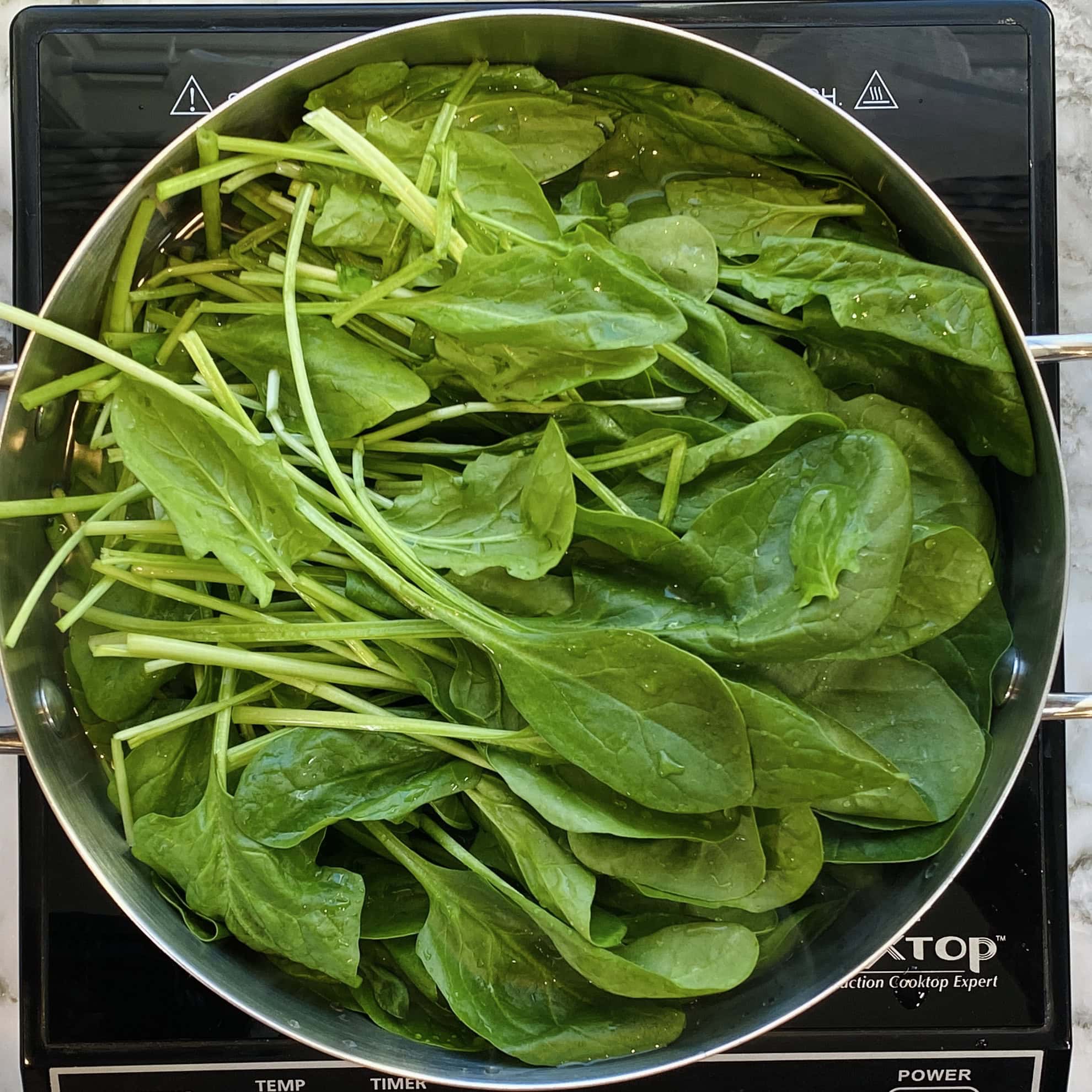 blanching spinach in a pot 