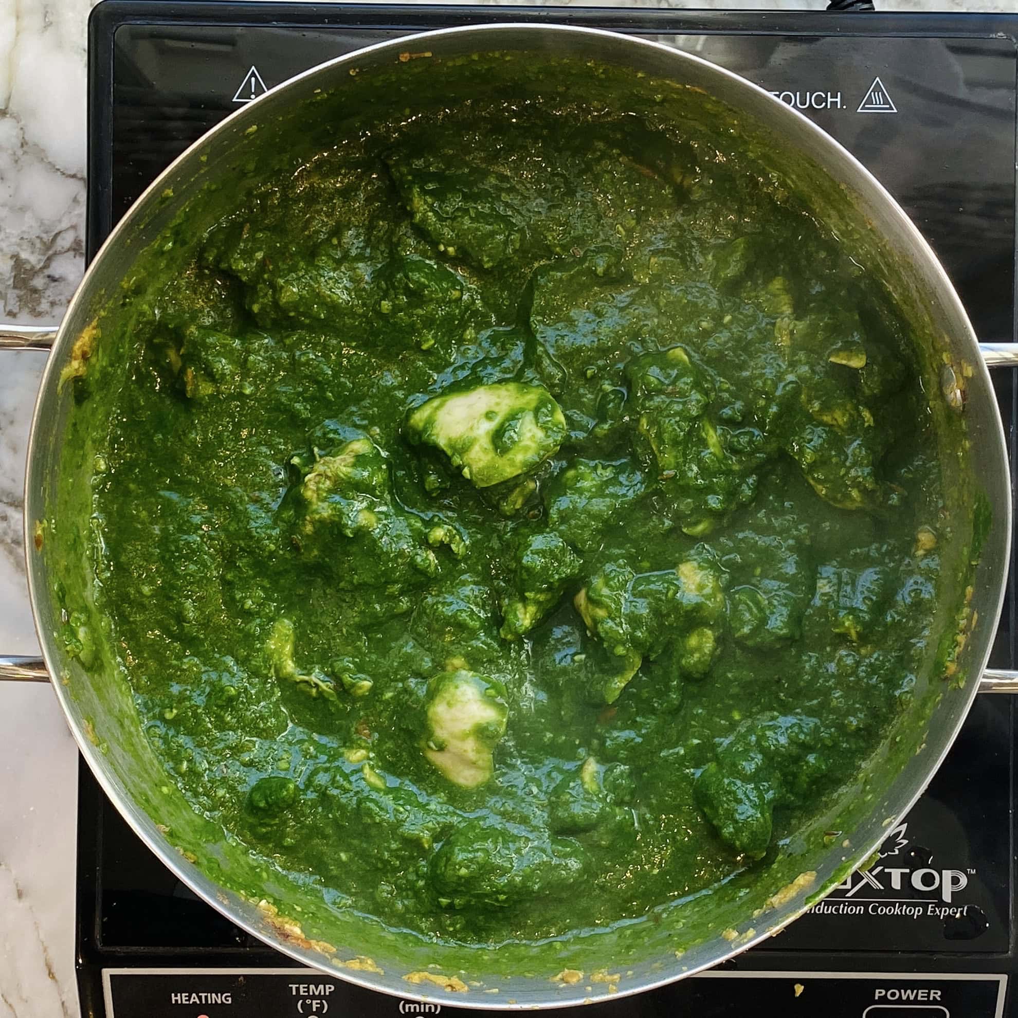 palak chicken curry in a pot 