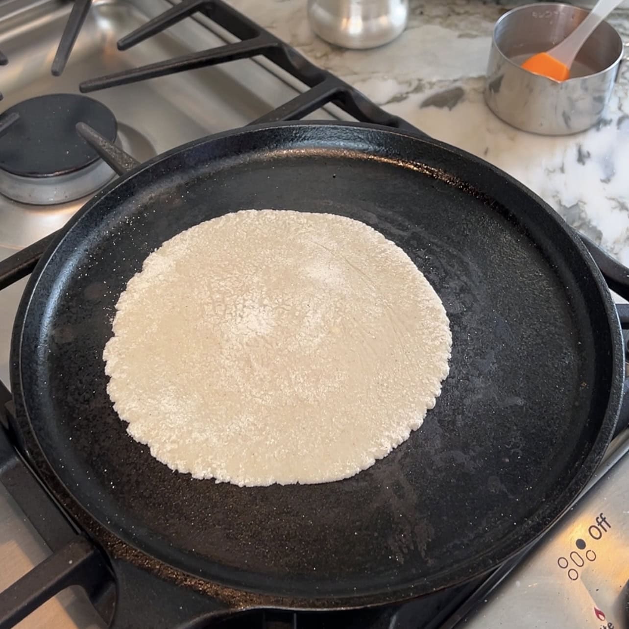 jowar roti on a cast iron pan