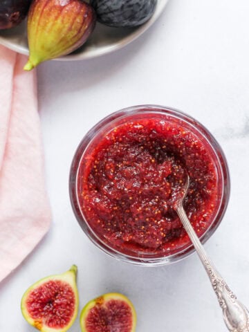 fig jam in a jar with fresh figs on the side