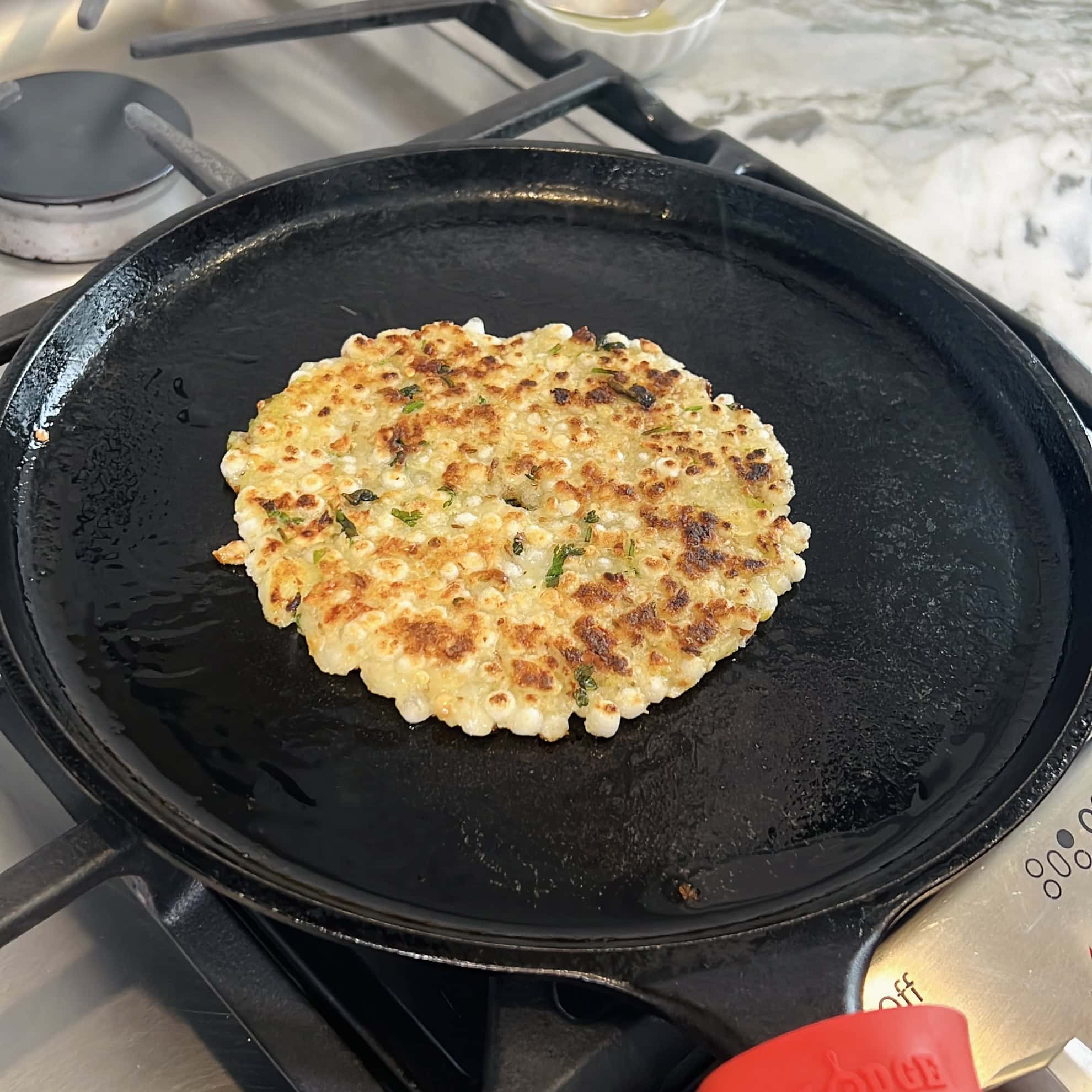 cooked sabudana thalipeeth on a ast iron pan 