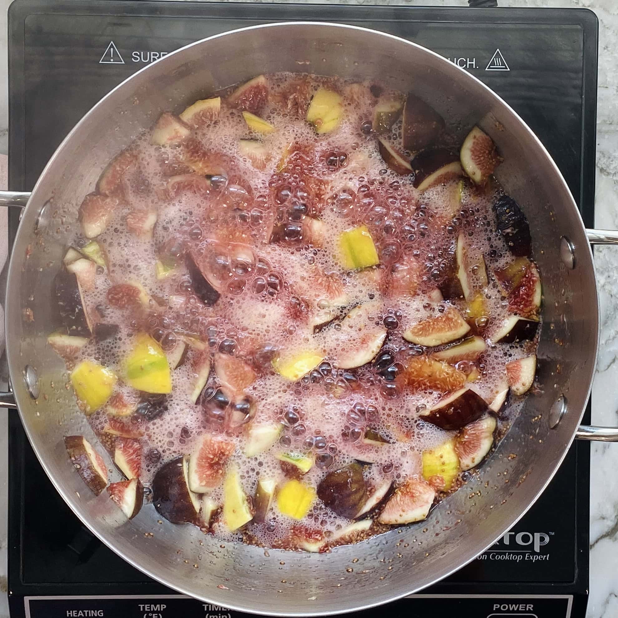fig jam ingredients boiling in a pan 