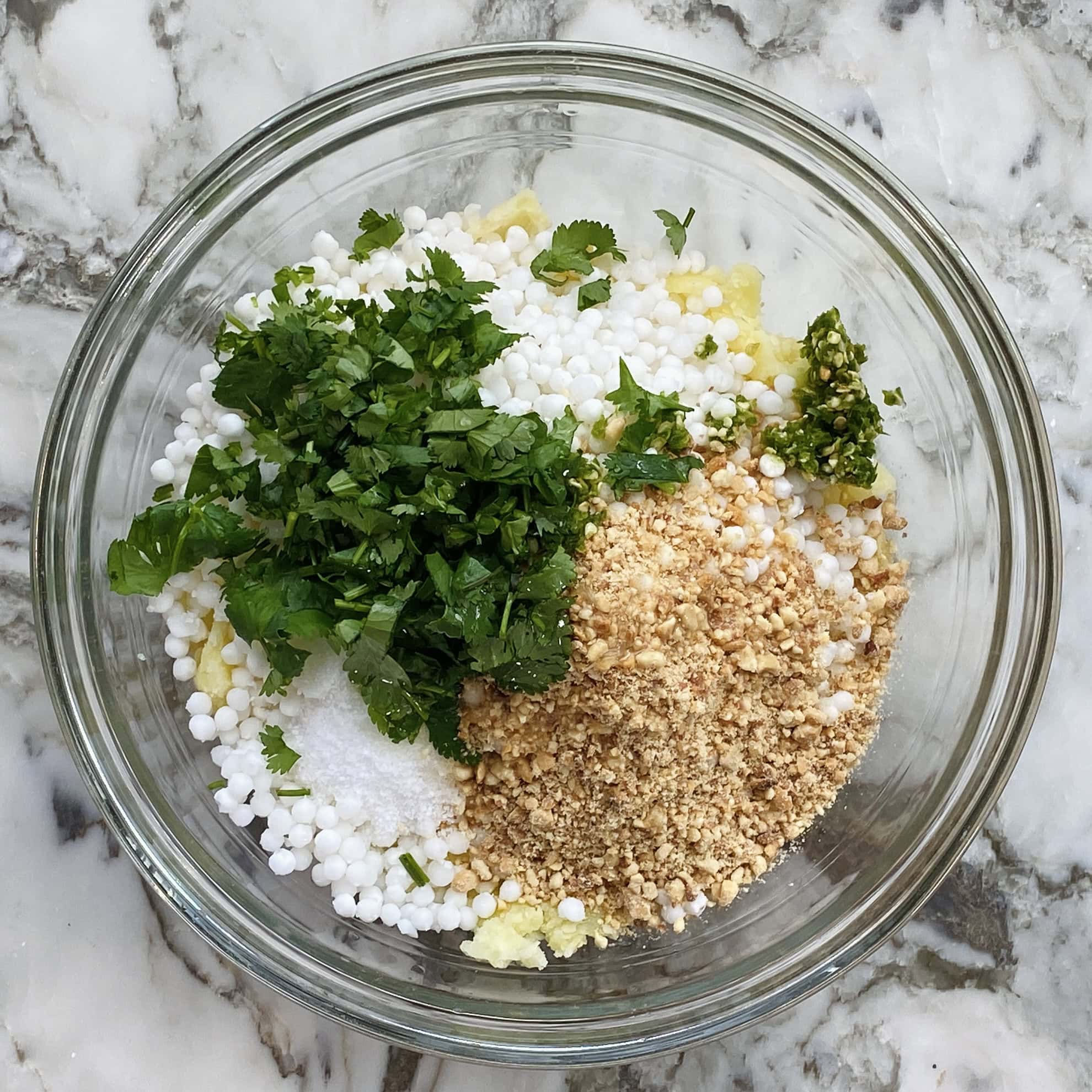 ingredients for sabudana thalipeeth in a bowl