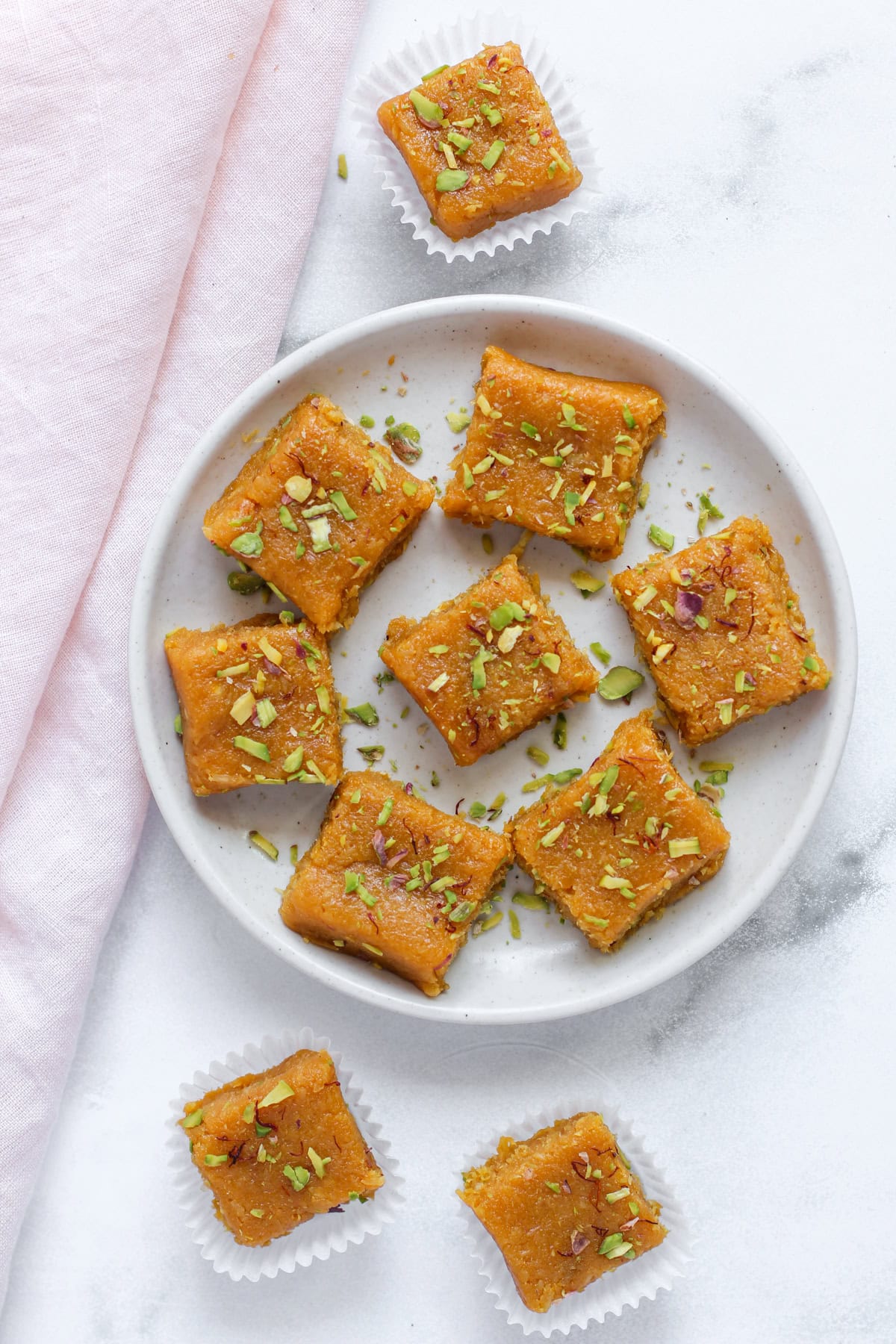 mango coconut burfi garnished with pistachios