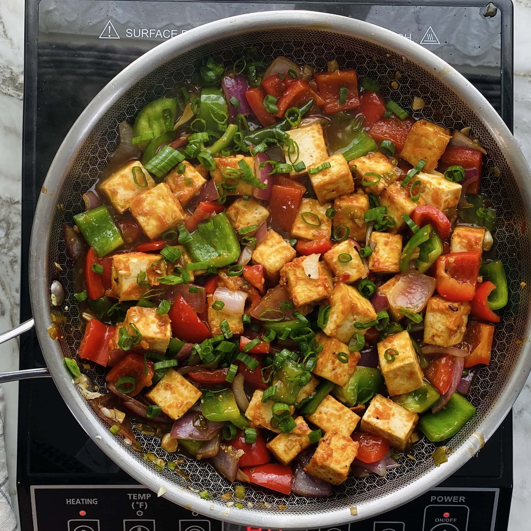 chilli tofu garnished with scallions