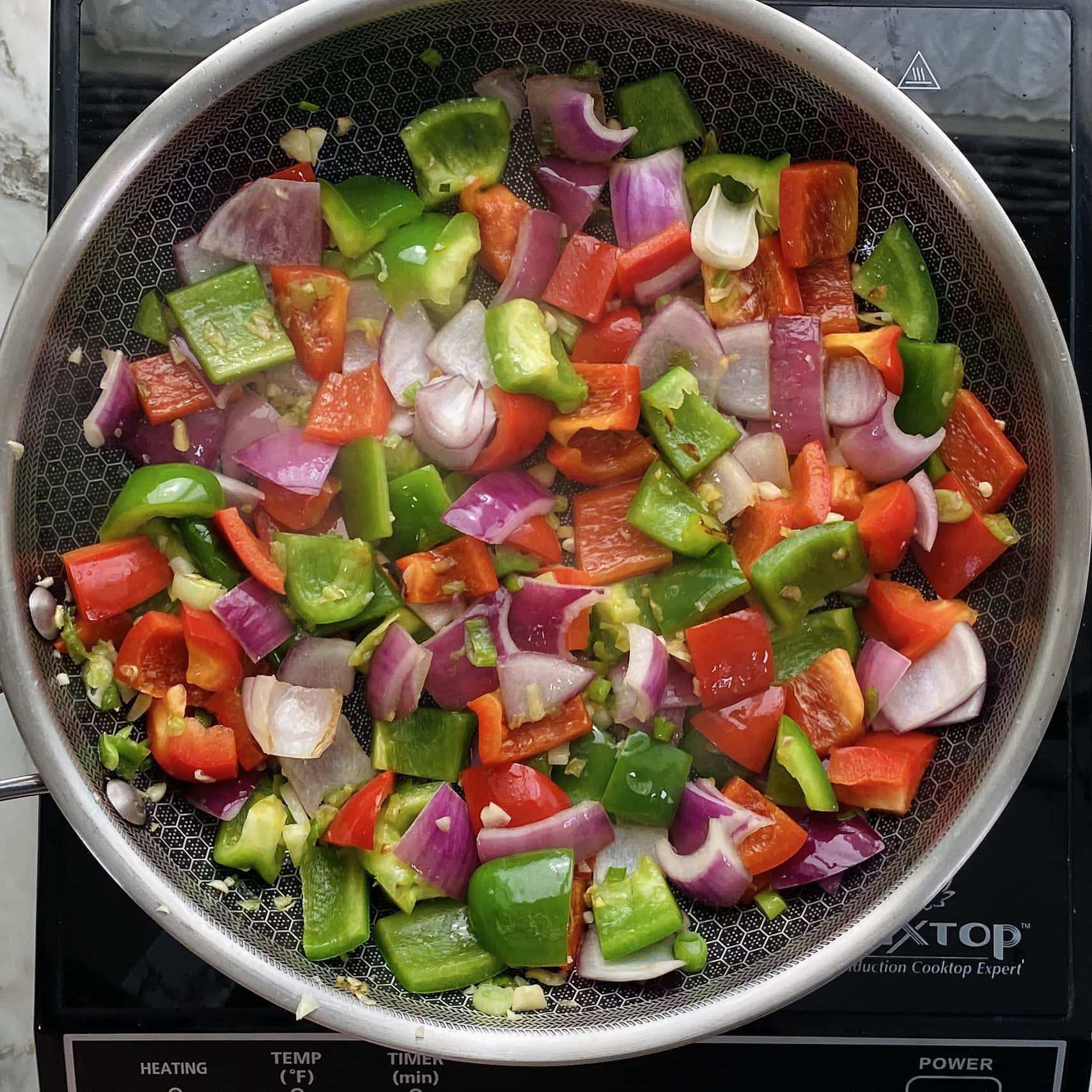sauteed peppers and onions in a pan 