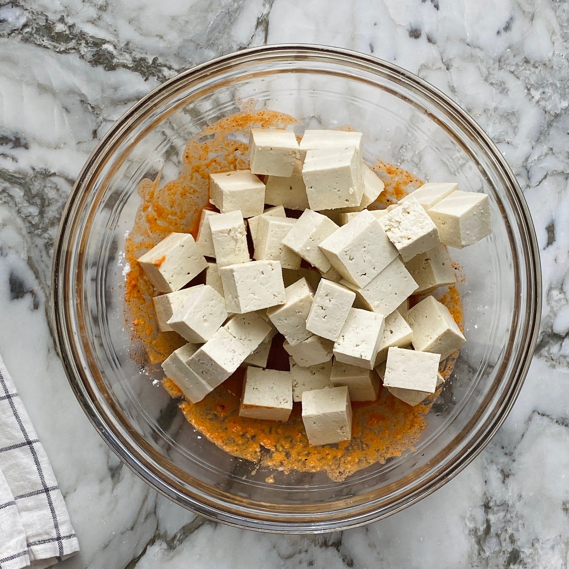 cubed tofu added to the marinade