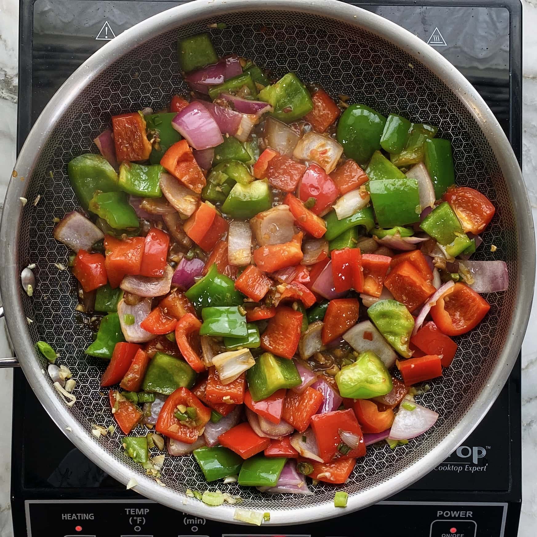 onions and peppers cooked in sauces 