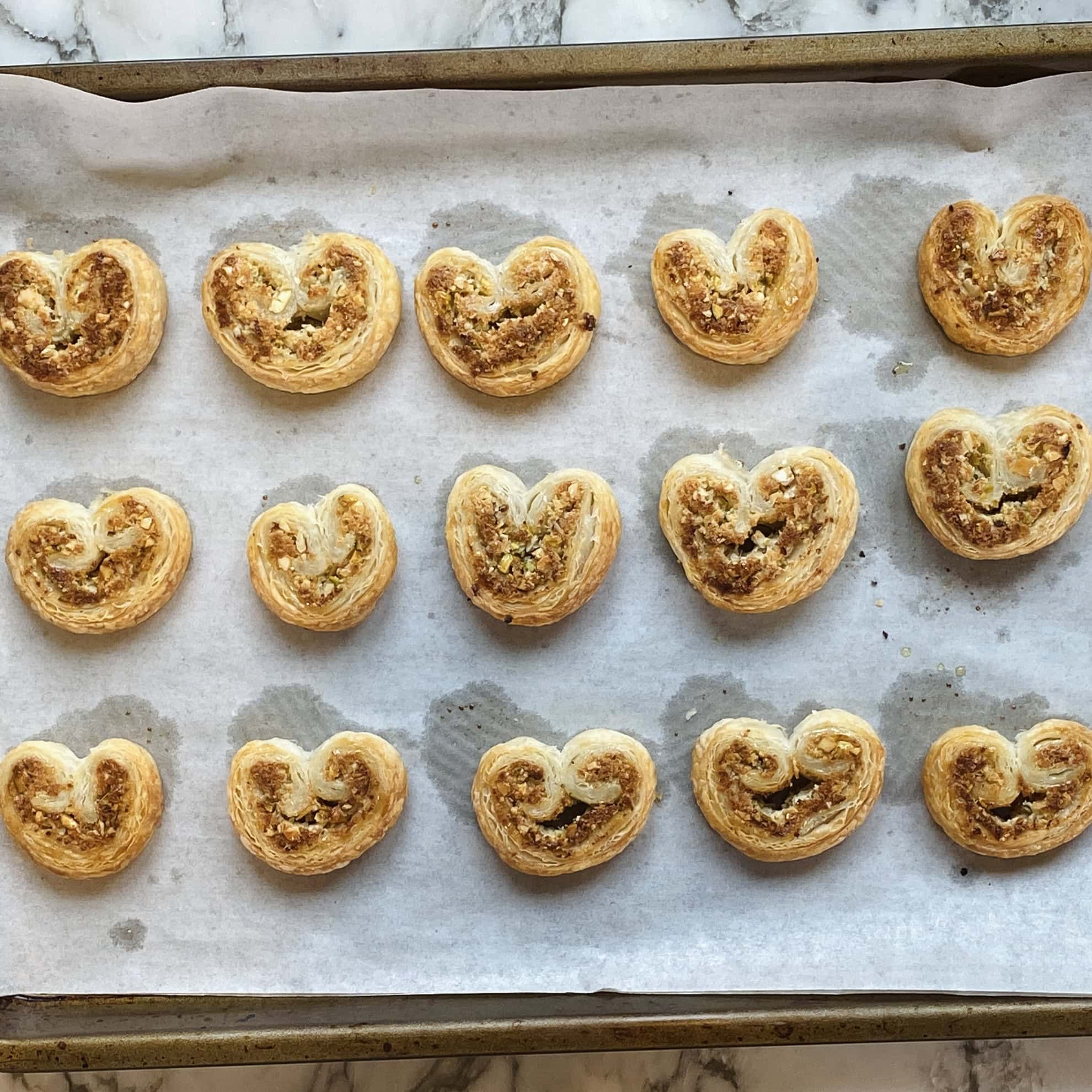 baked gujiya bites in a baking tray.