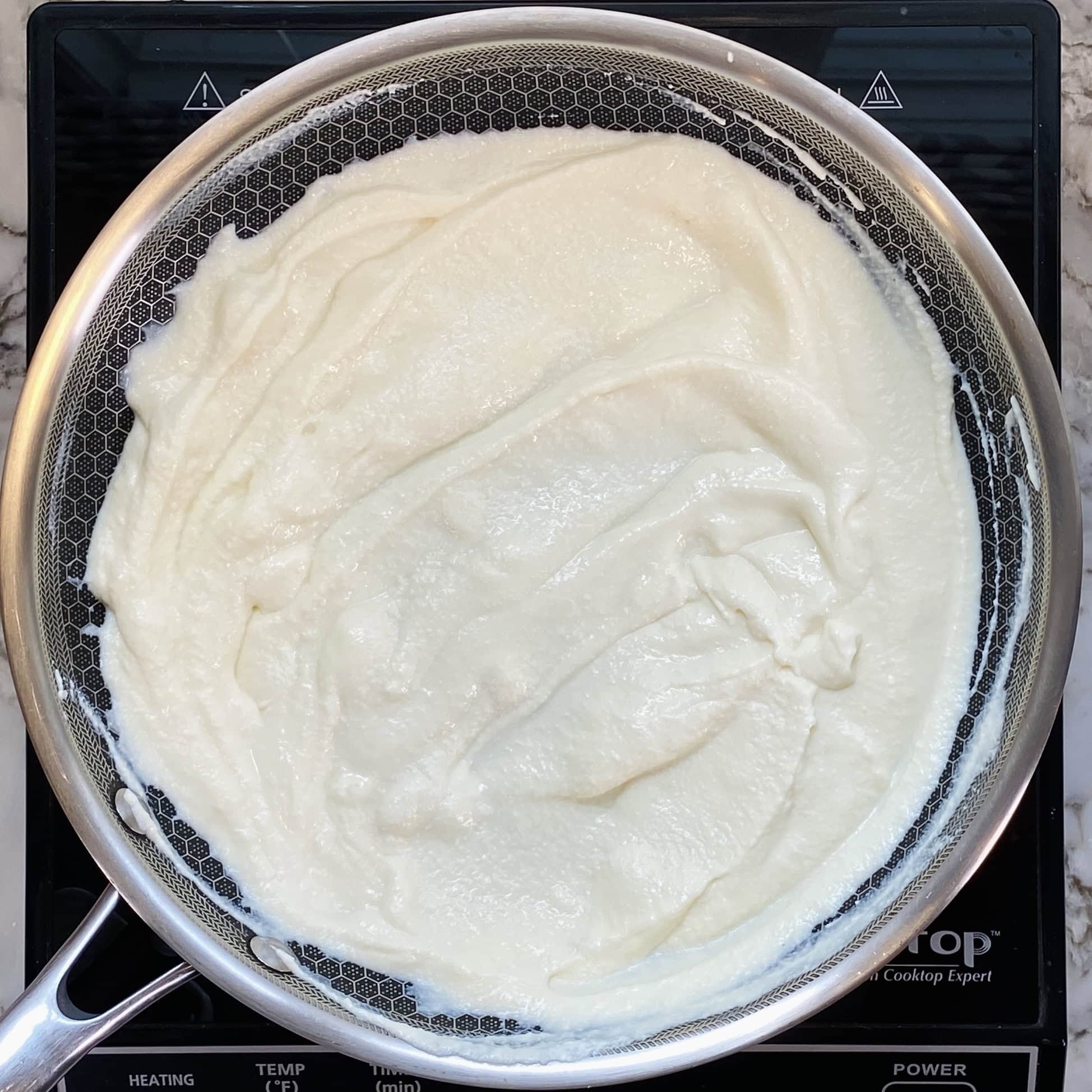 ricotta cheese with moisture evaporated in a pan 