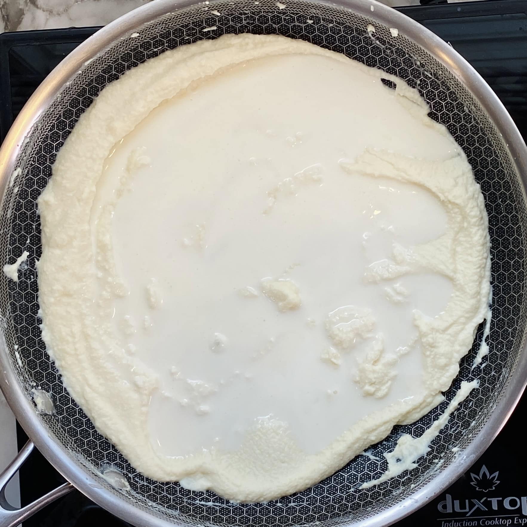 ricotta cheese with heavy cream in a pan 
