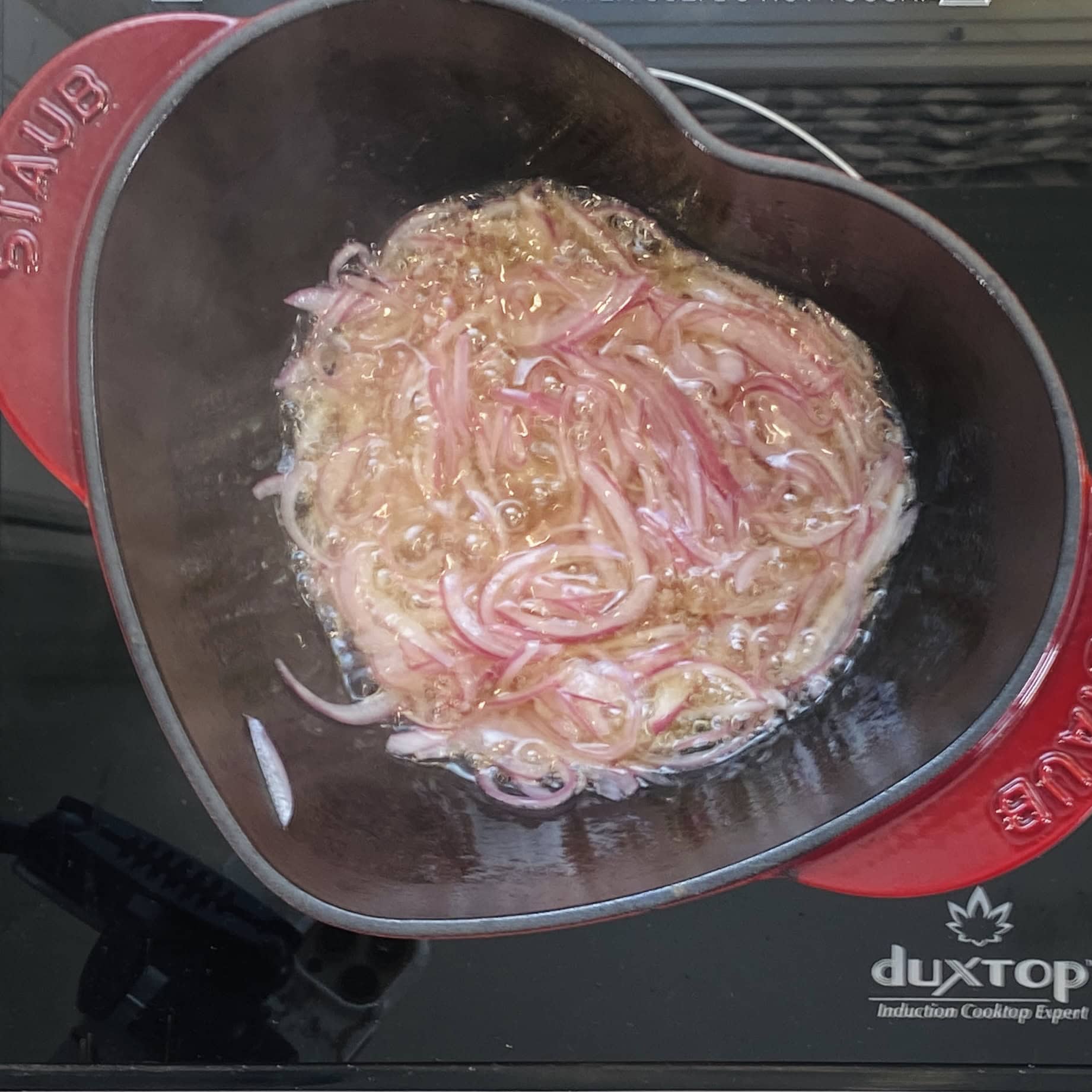 frying onions in a pot 