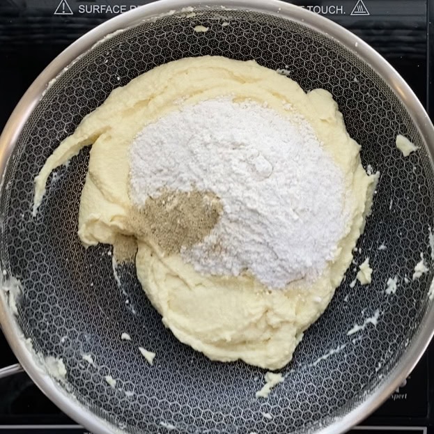 powdered sugar and cardamom powder added to cooked ricotta mixture 