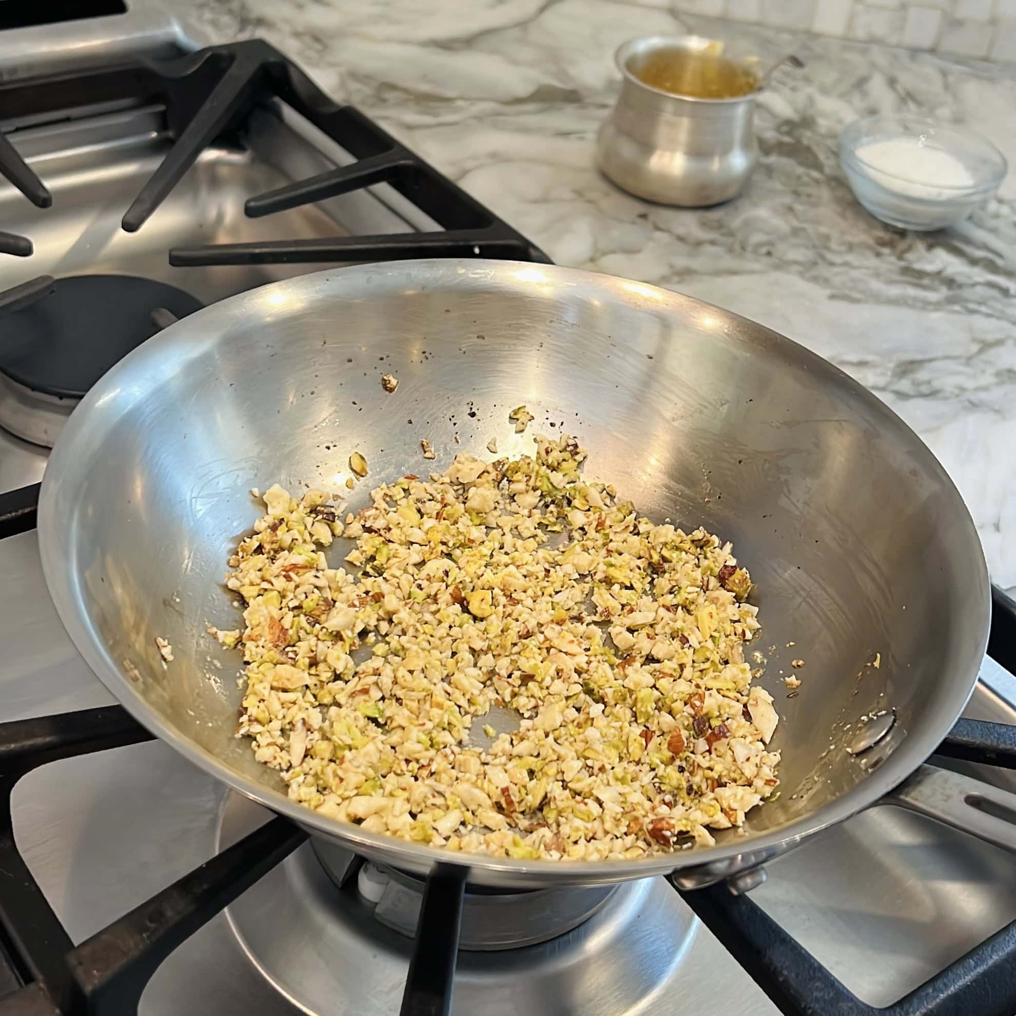 roasting chopped nuts in a pan. 