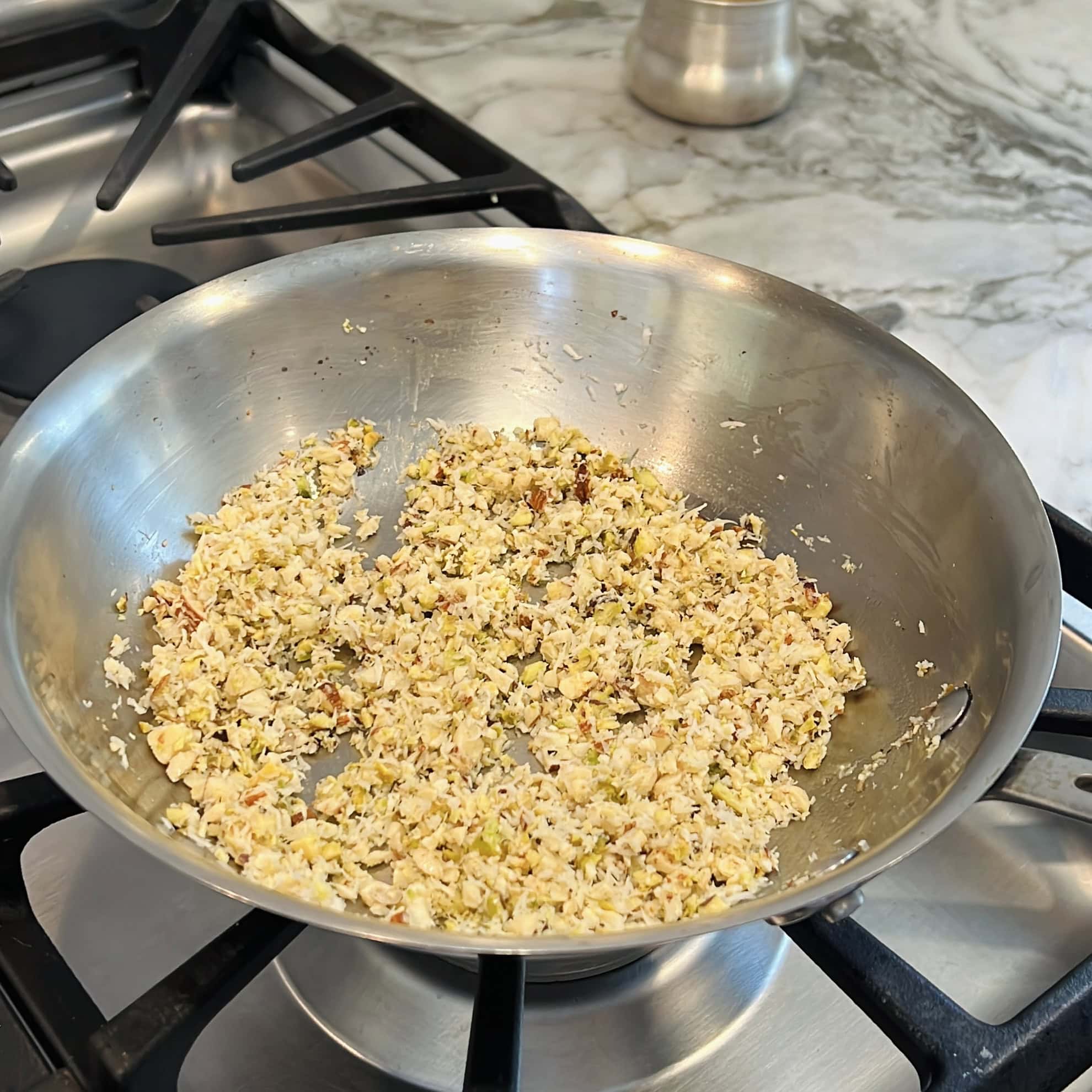roasted nuts and coconut in a pan. 