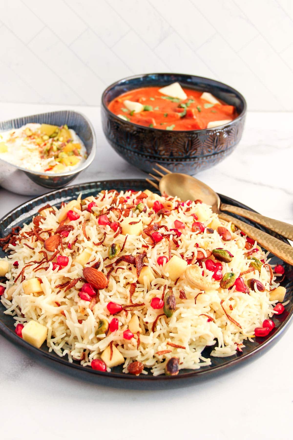 Kashmiri Pulao served with paneer makhani and pineapple raita 