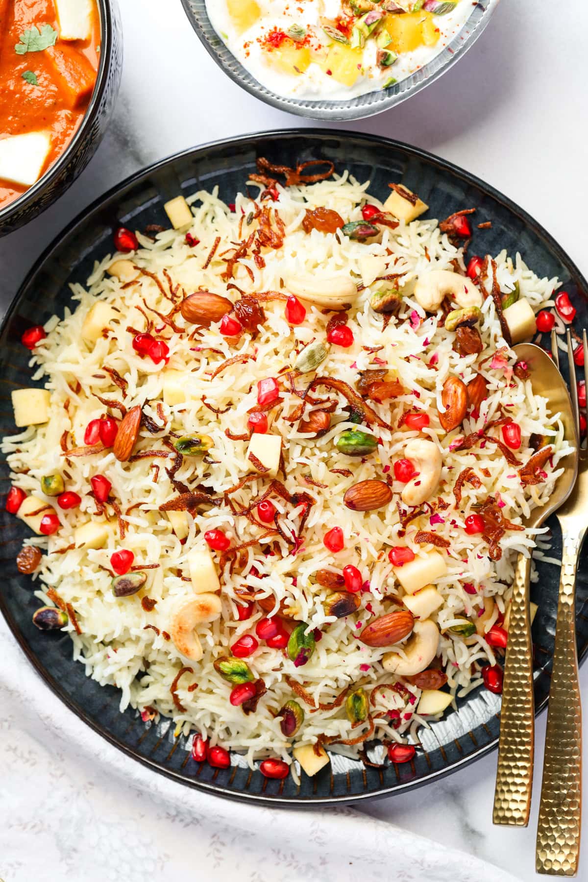 Kashmiri Pulao garnished wit nuts and pomogrante arils  