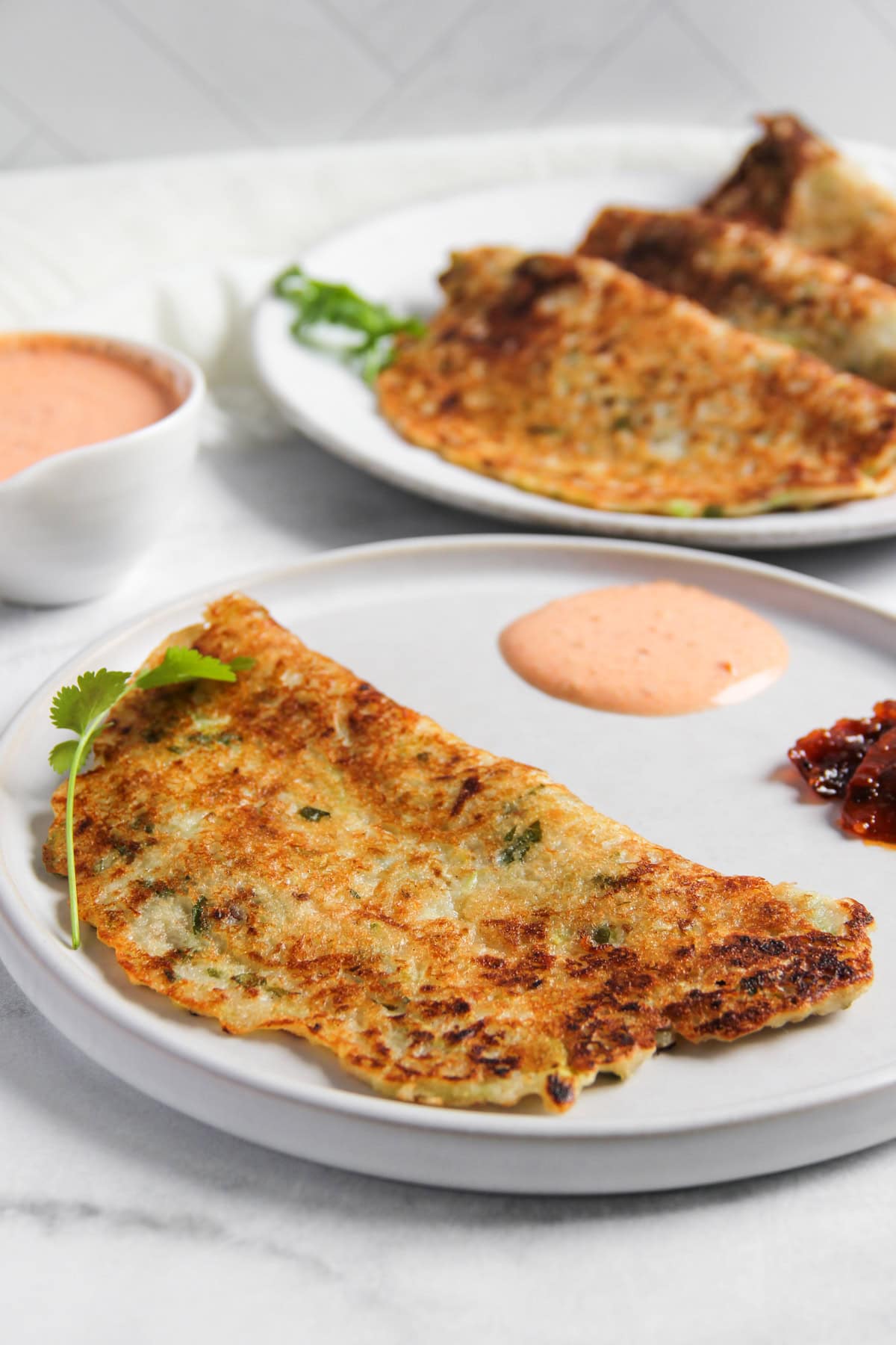 Dudhi Bhoplyache Dhirde served with pickle and yogurt chutney.