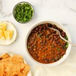 kala chana curry served with parathas and lemon wedges