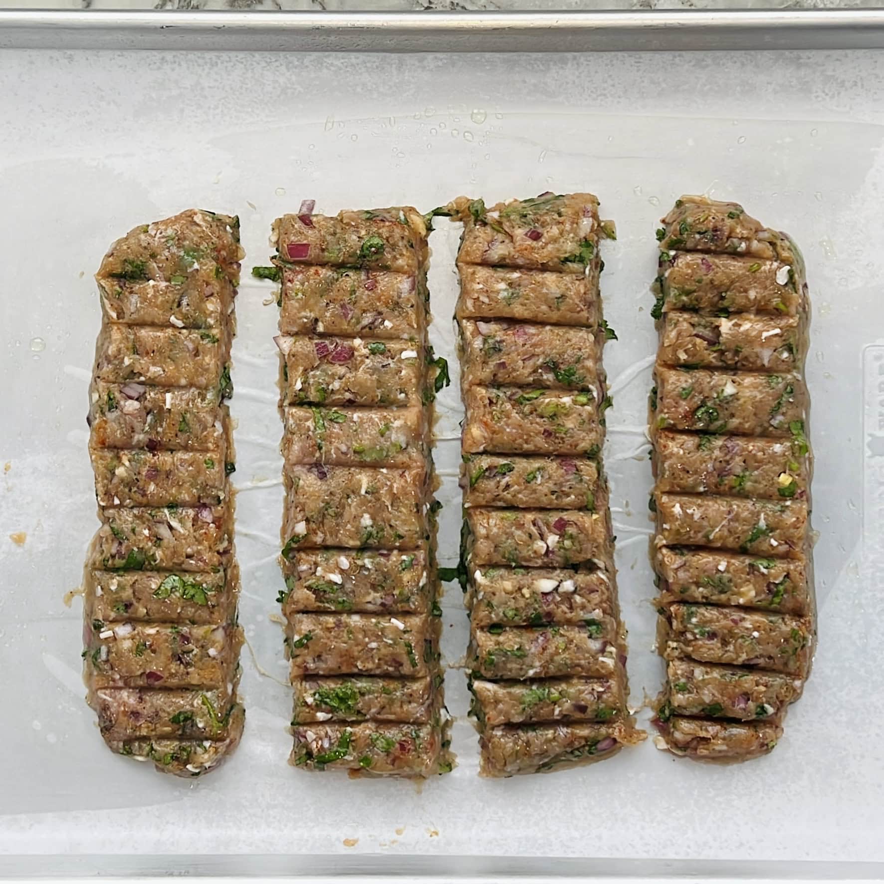 kebabs shaped on a sheet pan