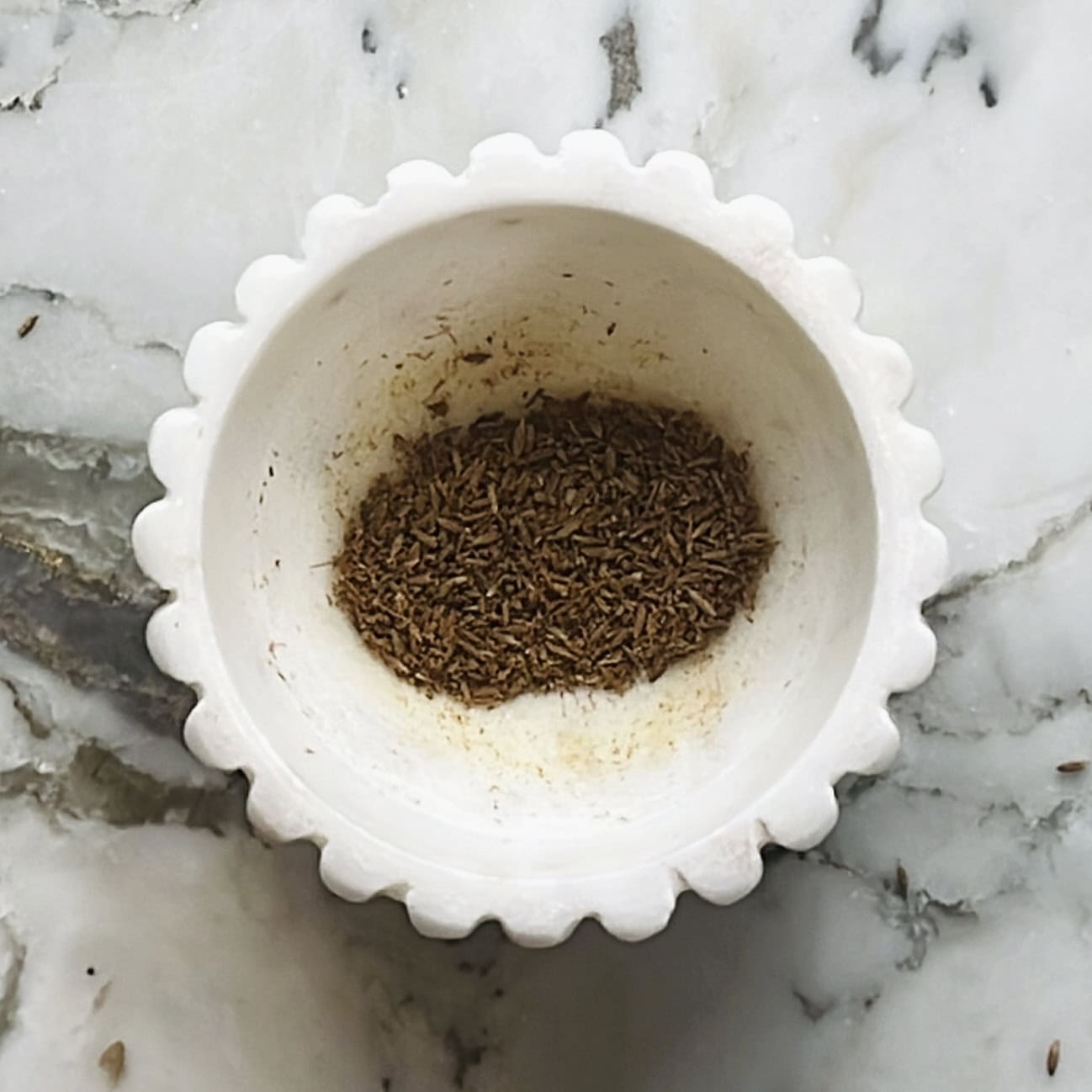 crushed roasted zeera in a mortar
