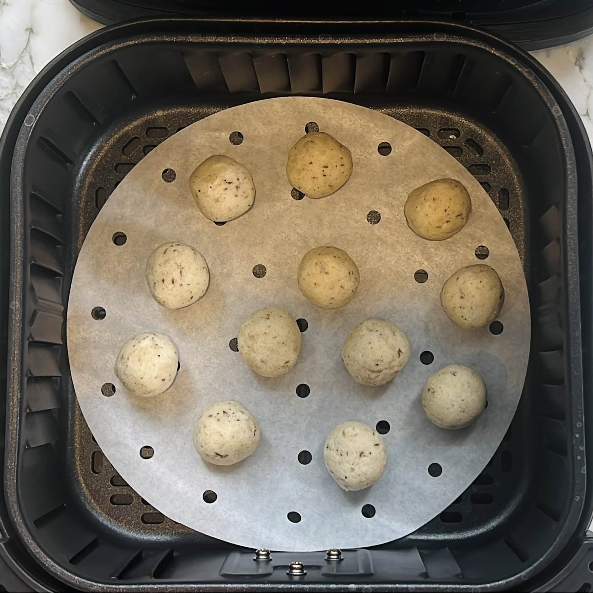 bagel bites lined in an air fryer basket