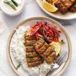 chicken seekh kebab served with laccha pyaaz over basmati rice