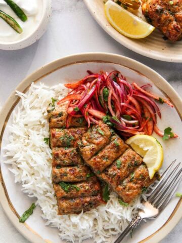 chicken seekh kebab served with laccha pyaaz over basmati rice