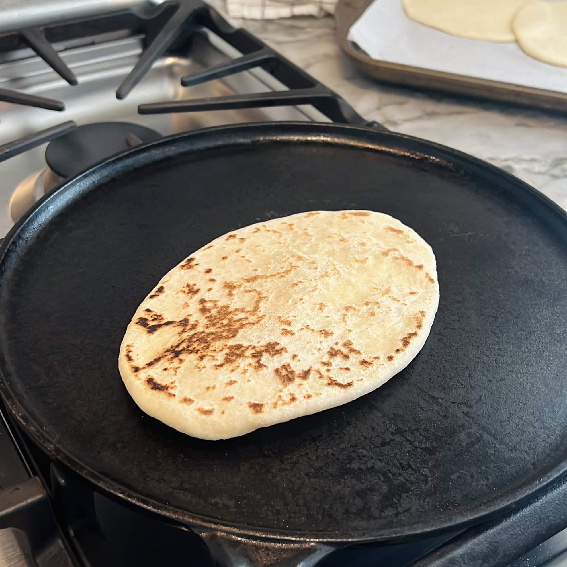 turned over naan on a hot pan.