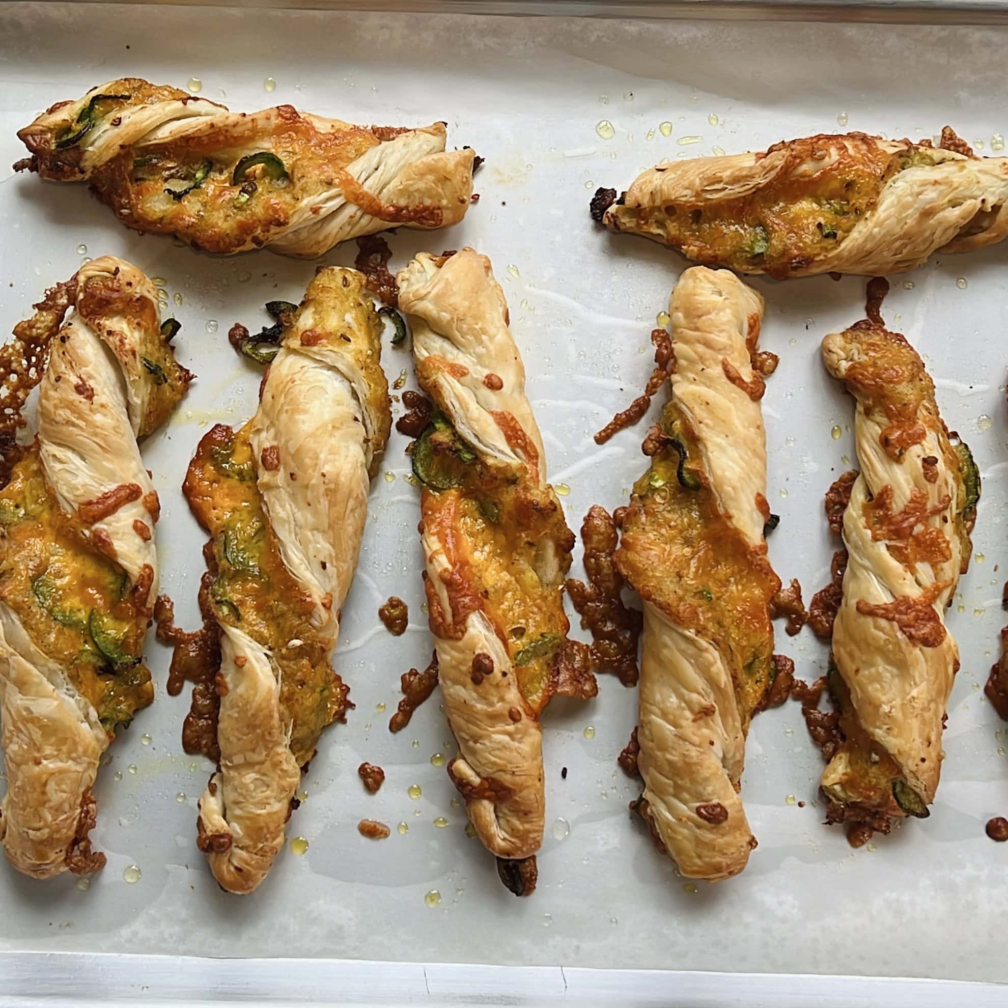 Baked Cheesy Jalapeno Samosa Twists on a baking tray.