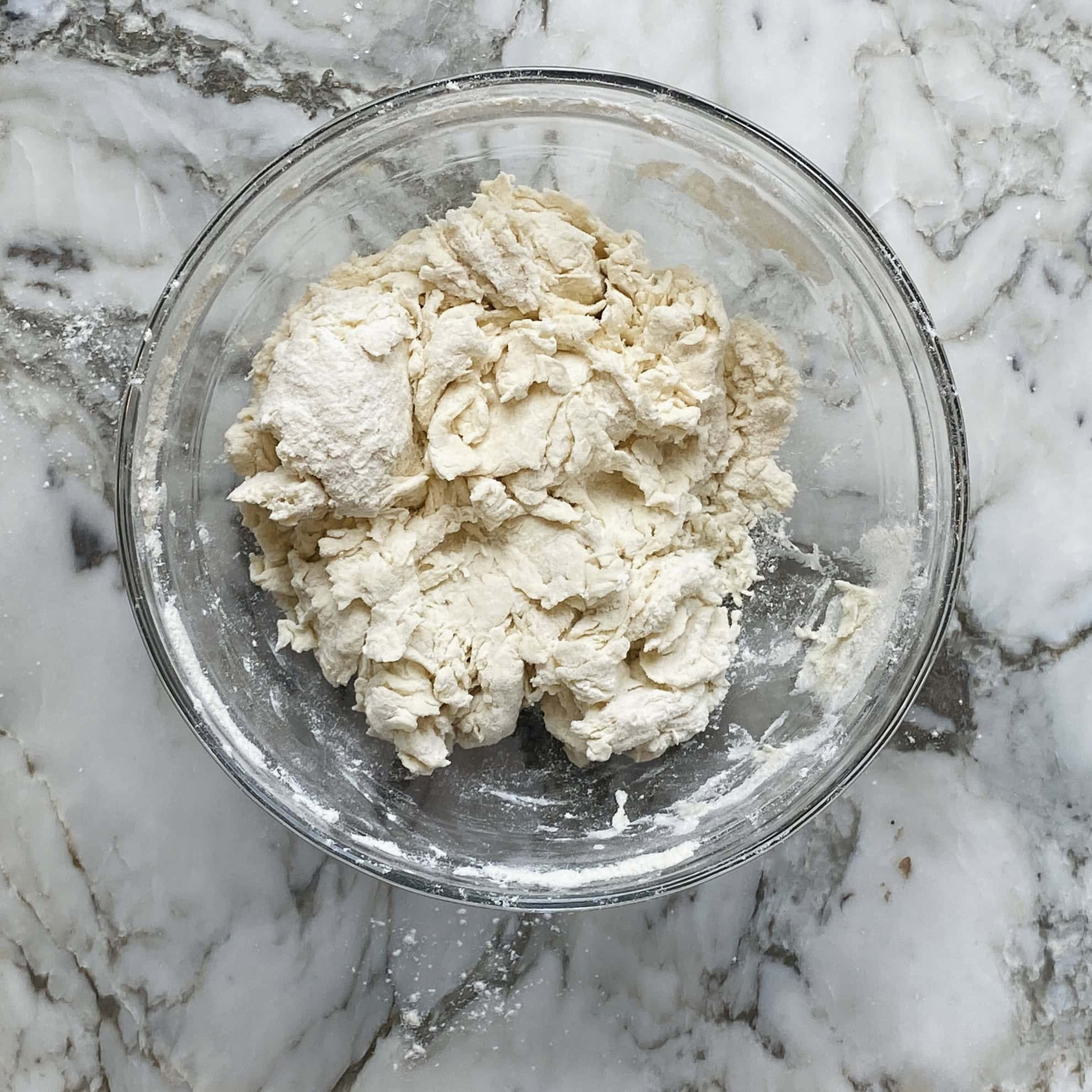 naan dough ingredients mixed in a bowl