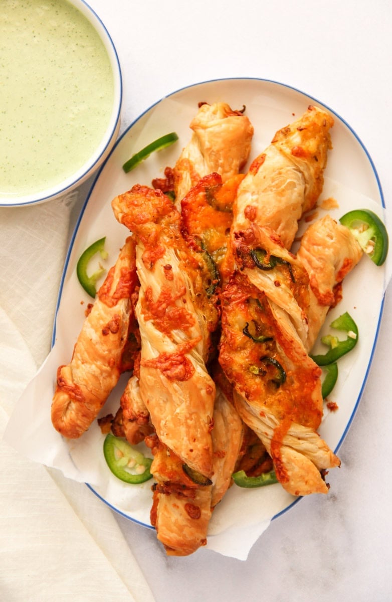 Cheesy Jalapeno Samosa Twists on a served with chutney aiolii dip.