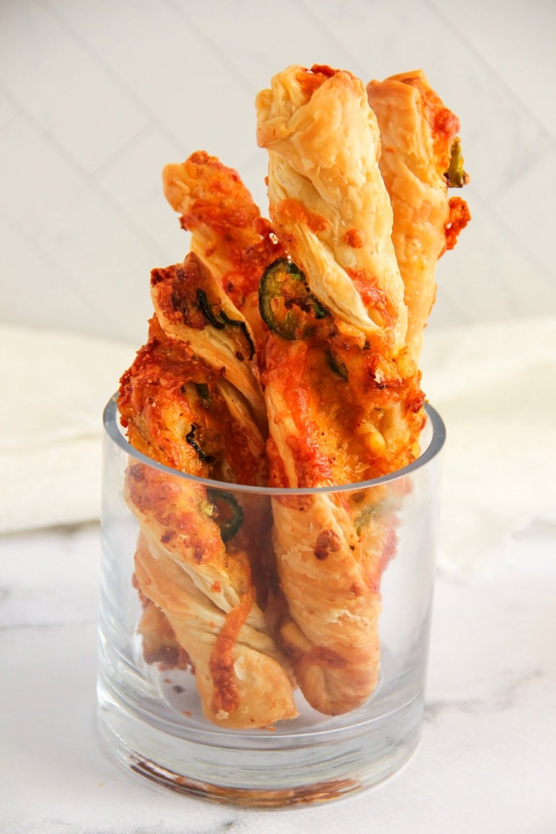 jalapeno cheese twists served in a glass jar.