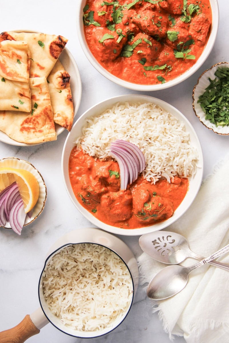 chicken tikka masala served with rice and naan.