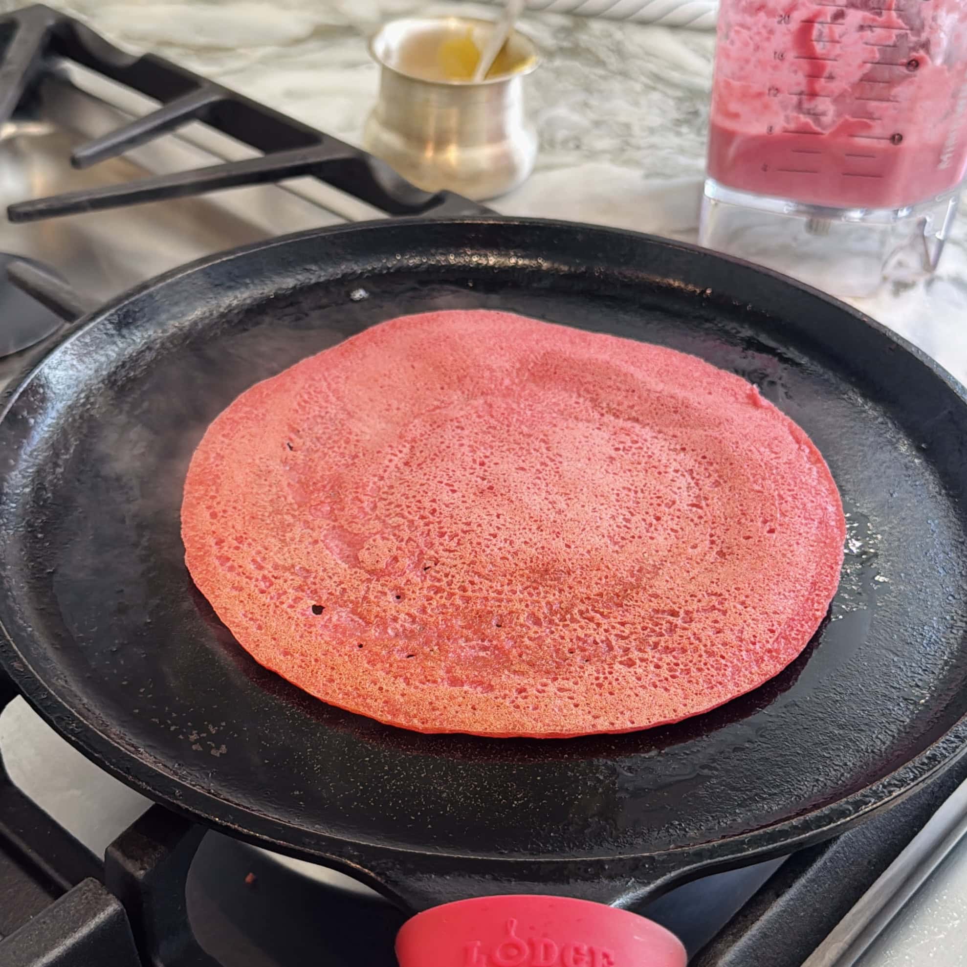 beet chilla on cast iron pan.