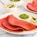 beet chillas served with cilantro chutney and coconut chutney.