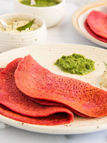 beet chillas served with cilantro chutney and coconut chutney.